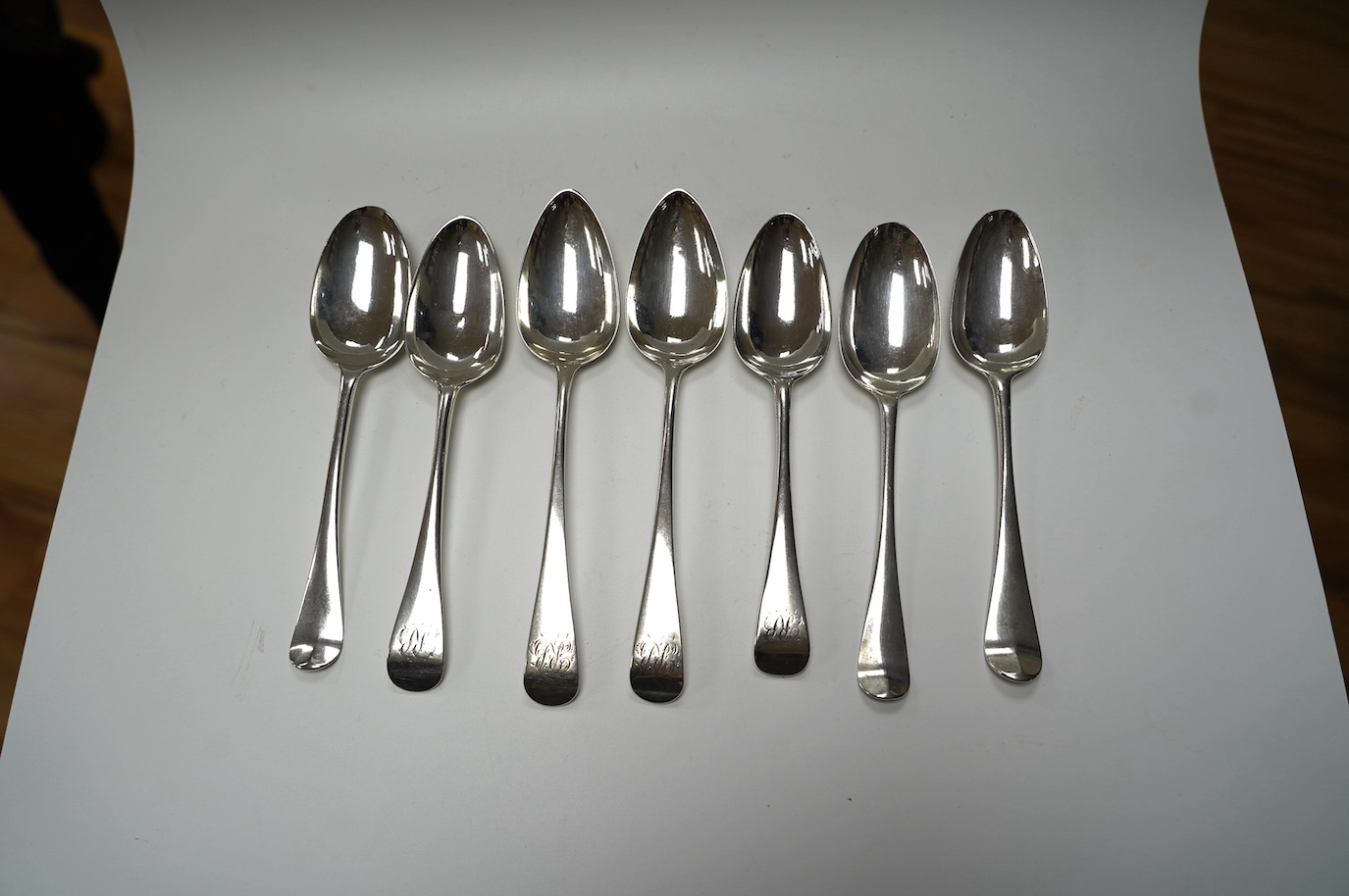 A pair of George III silver Old English pattern table spoons, Thomas Wallis II, London, 1798, 21.9cm and four earlier silver base mark table spoons, 14.3oz. Condition - poor to fair